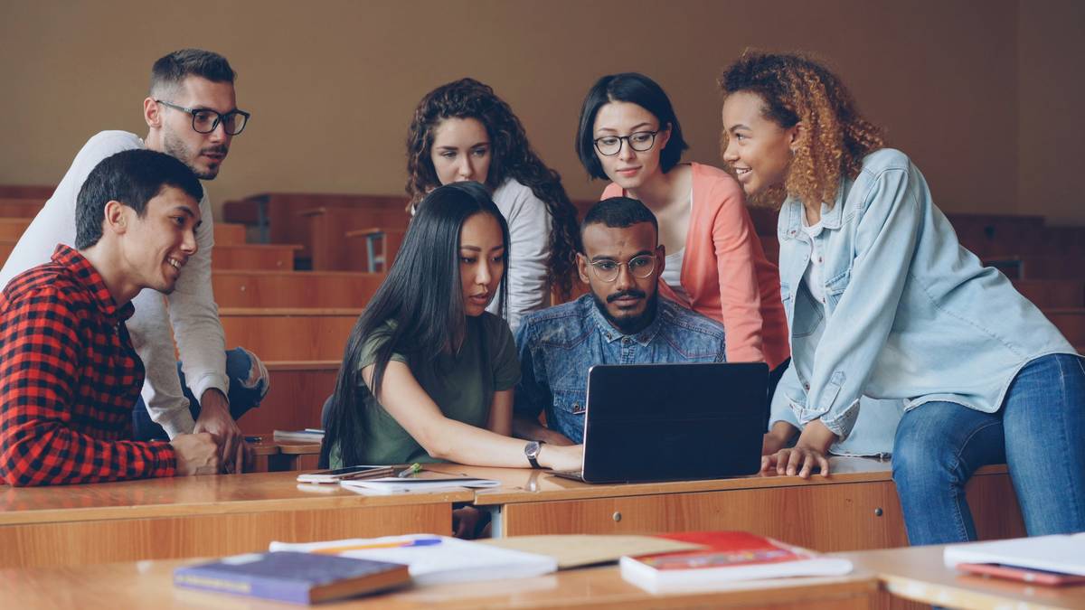 cultural sensitivity intercultural competence how to: diverse professionals collaborating in a virtual meeting with flags and digital avatars